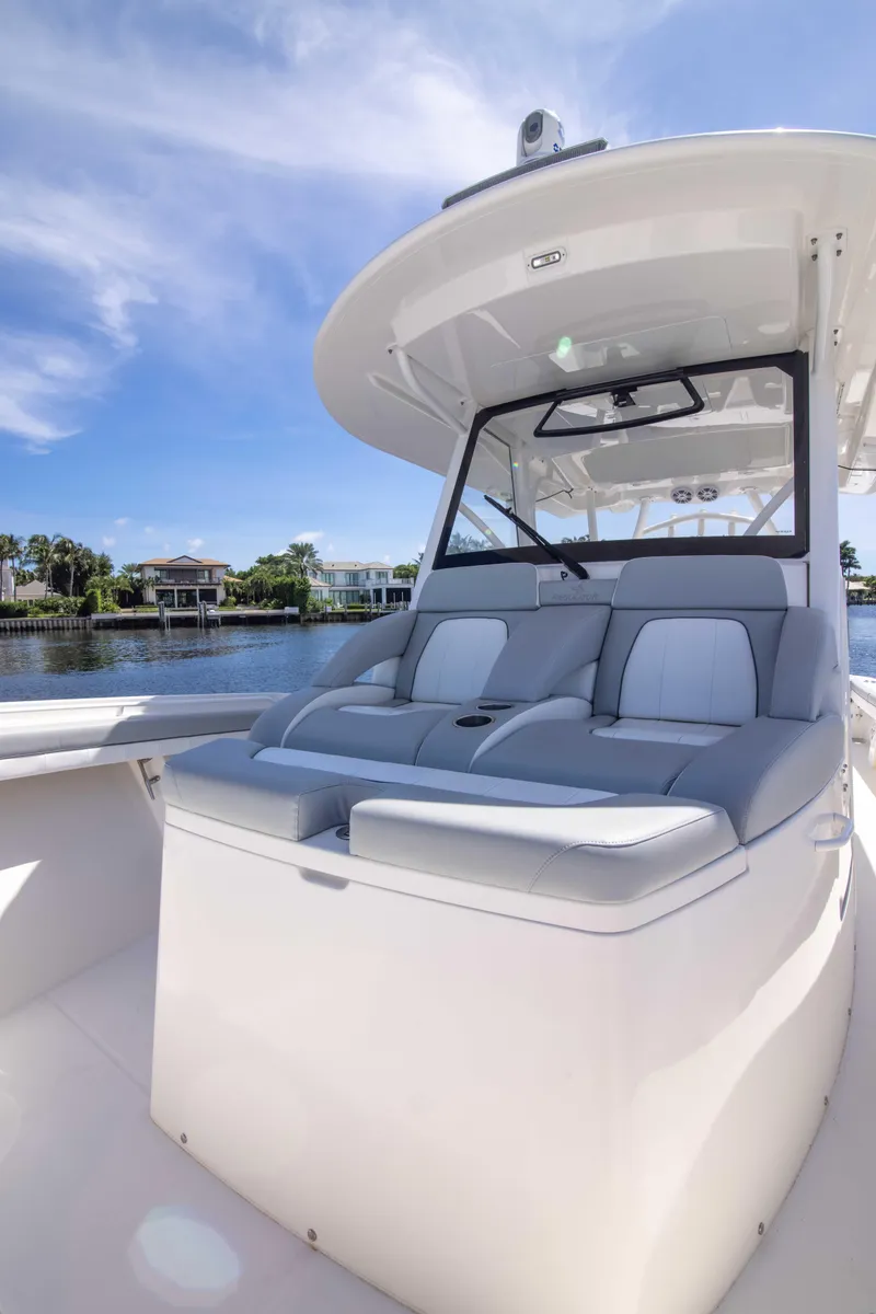 Slide: The Image of 2021 Regulator 41 boat with sleek seating, under a clear blue sky. - 16