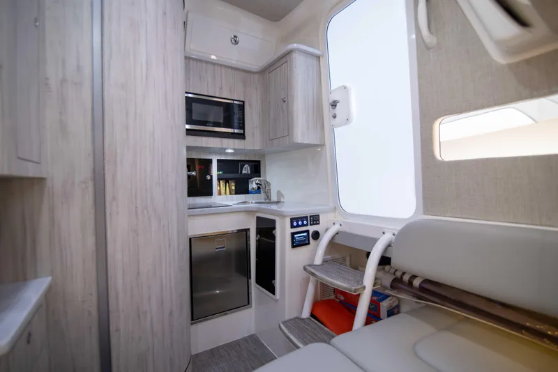 Slide: The Image of Modern 2021 Regulator 41 boat interior with kitchenette and seating area. - 20