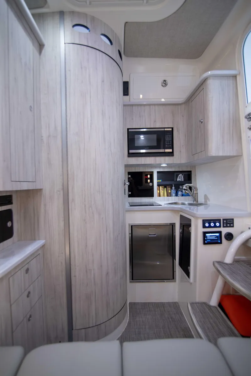 Slide: The Image of Modern kitchen interior in 2021 Regulator 41 boat, featuring sleek cabinetry and appliances. - 21