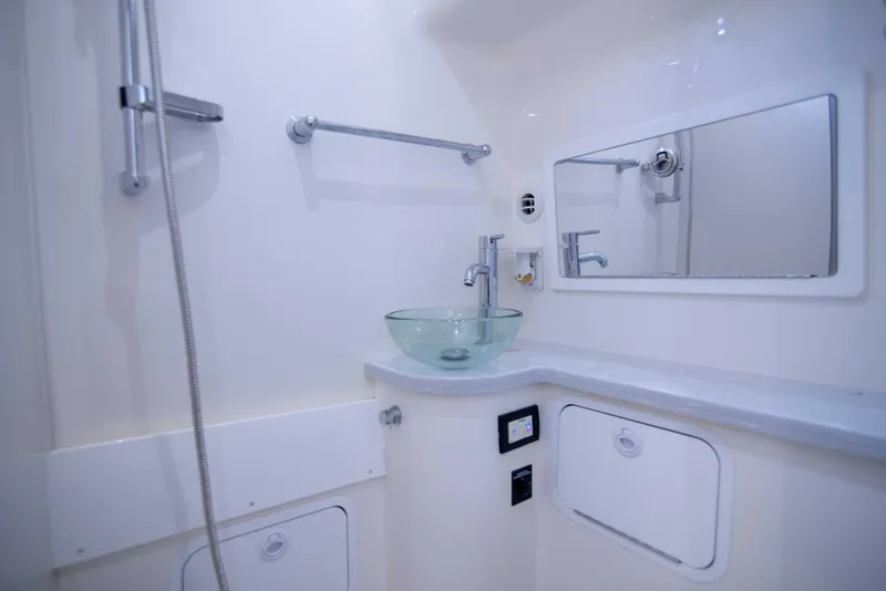 Slide: The Image of 2021 Regulator 41 boat bathroom with glass sink and mirror. - 26