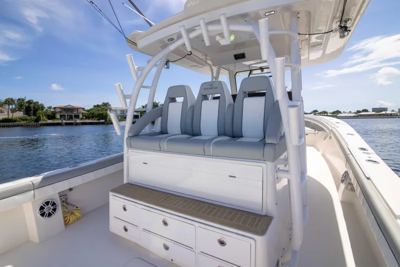 Slide: The Image of 2021 Regulator 41 boat interior with seating and storage, docked by the water. - 28
