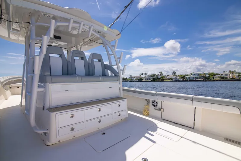 Slide: The Image of 2021 Regulator 41 boat interior with seating and storage, overlooking a scenic waterfront. - 29