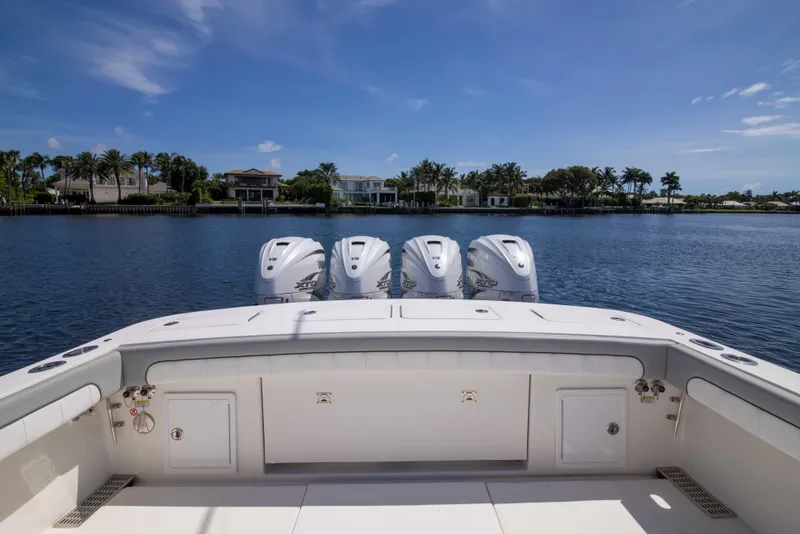 Slide: The Image of 2021 Regulator 41 boat with four engines on a calm waterfront. - 34