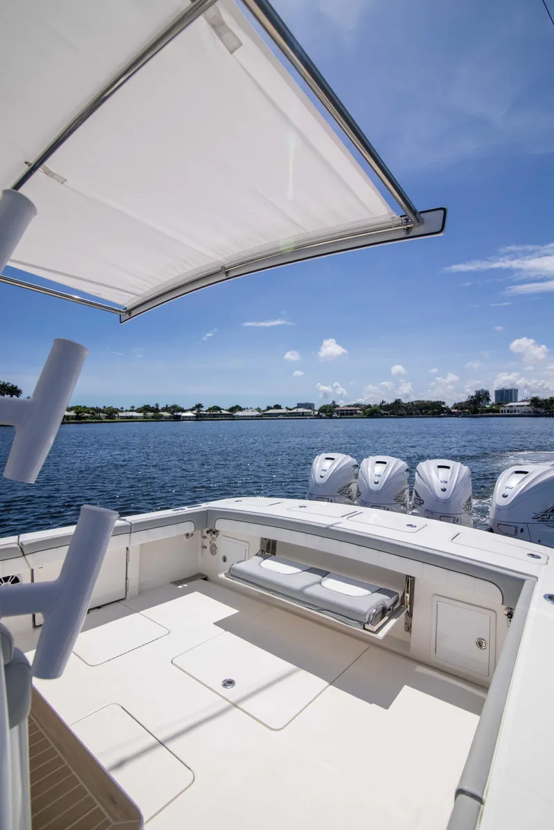 Slide: The Image of 2021 Regulator 41 boat with multiple engines, spacious deck, and scenic water view. - 35