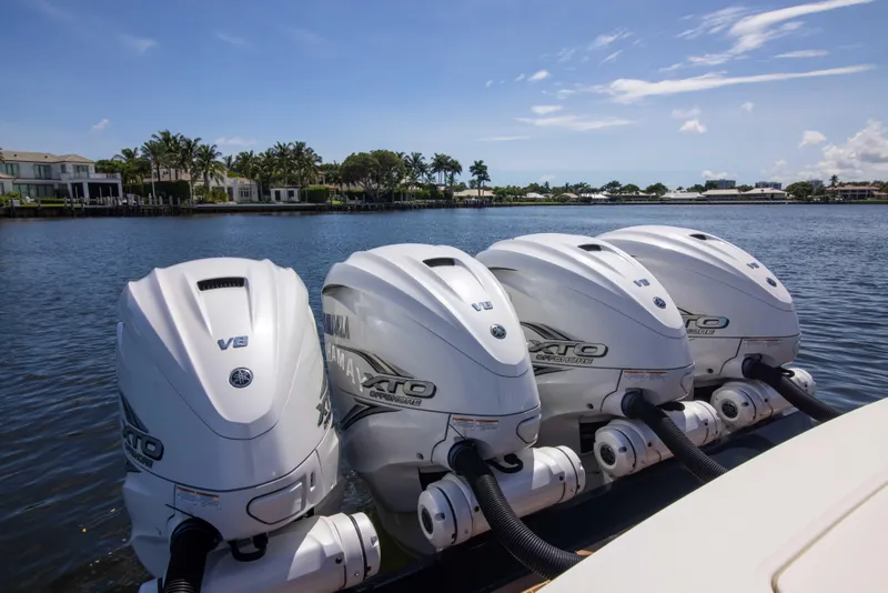 Slide: The Image of 2021 Regulator 41 boat with four Yamaha XTO V8 outboard engines on a scenic waterway. - 39
