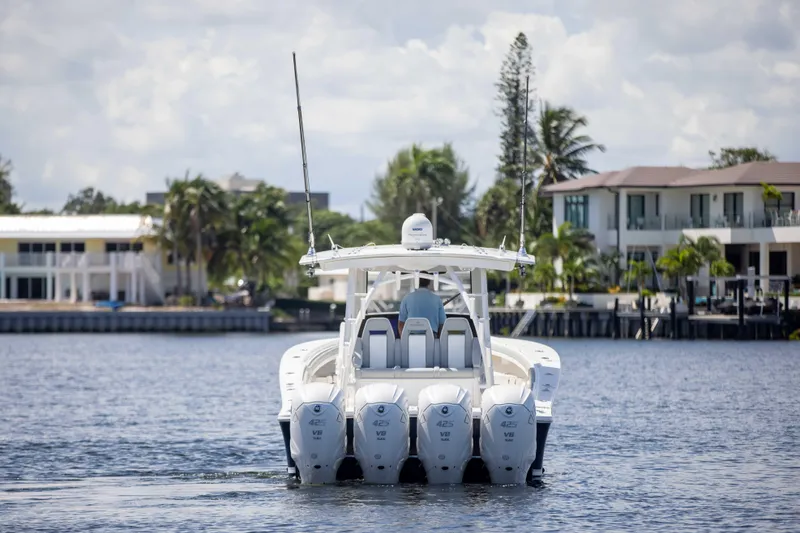 Slide: The Image of 2021 Regulator 41 boat with four engines cruising on a sunny waterfront. - 41