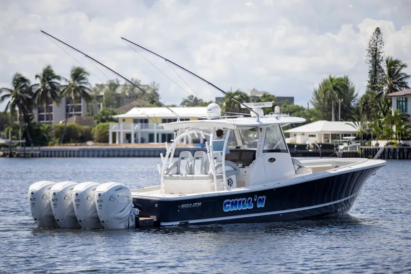 Slide: The Image of 2021 Regulator 41 boat with four engines on a calm waterway. - 42
