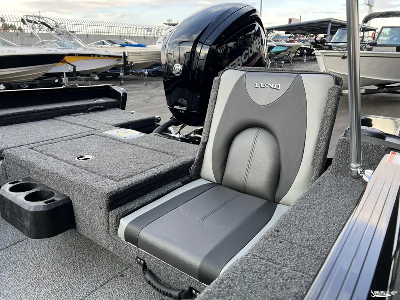 Slide: The Image of 2025 Lund 1675 Adventure Sport boat interior with cushioned seating and Mercury engine. - 15