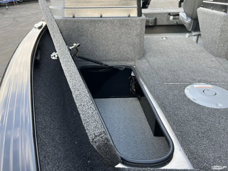 Slide: The Image of 2025 Lund 1675 Adventure Sport boat interior storage compartment open. - 16