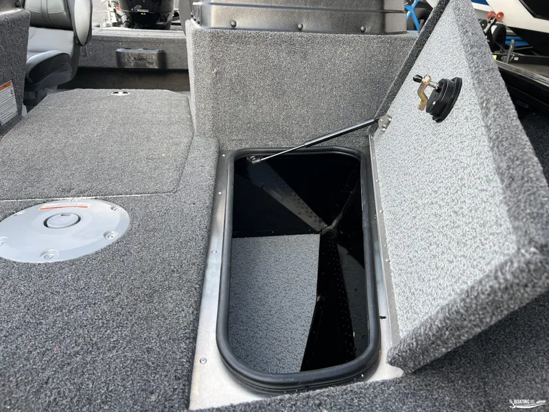 Slide: The Image of 2025 Lund 1675 Adventure Sport boat interior with open storage compartment. - 17
