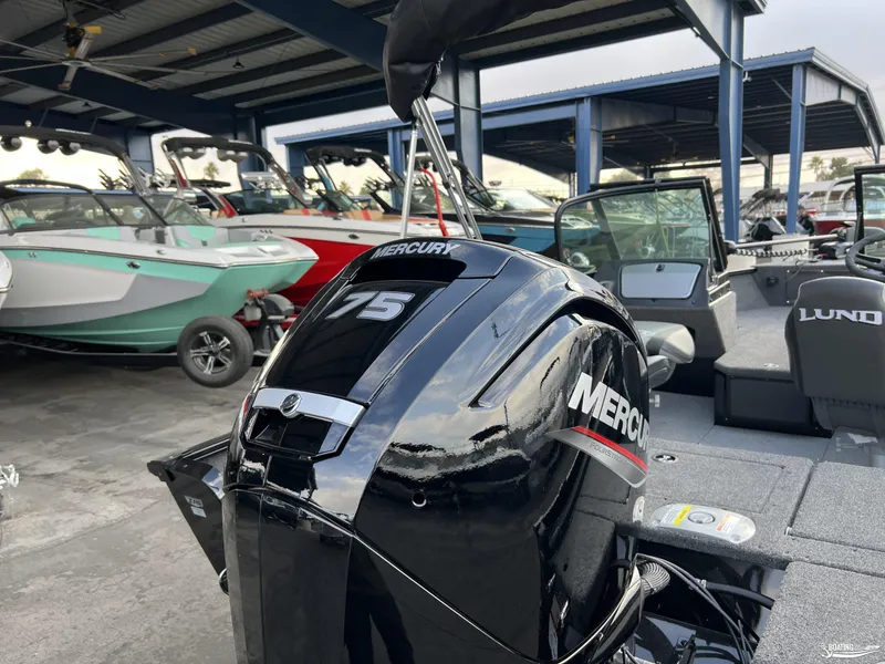 Slide: The Image of 2025 Lund 1675 Adventure Sport with Mercury 75 outboard motor in a boat showroom. - 19