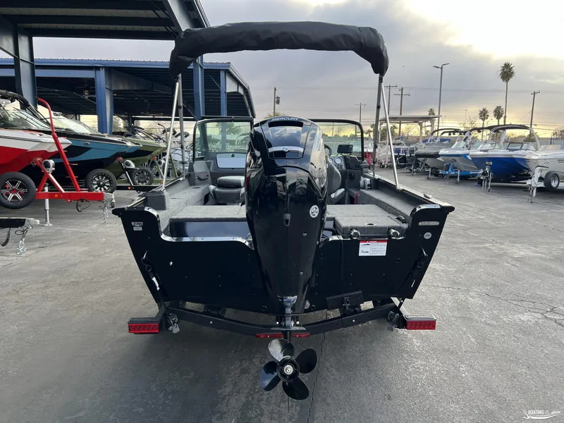 Slide: The Image of 2025 Lund 1675 Adventure Sport boat with outboard motor, parked in a marina. - 3