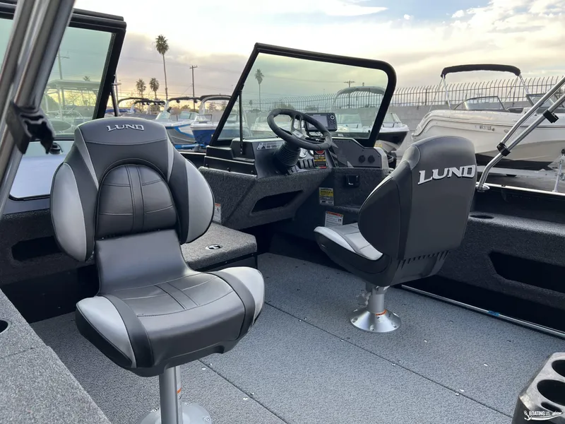Slide: The Image of 2025 Lund 1675 Adventure Sport boat interior with two seats and steering console. - 6