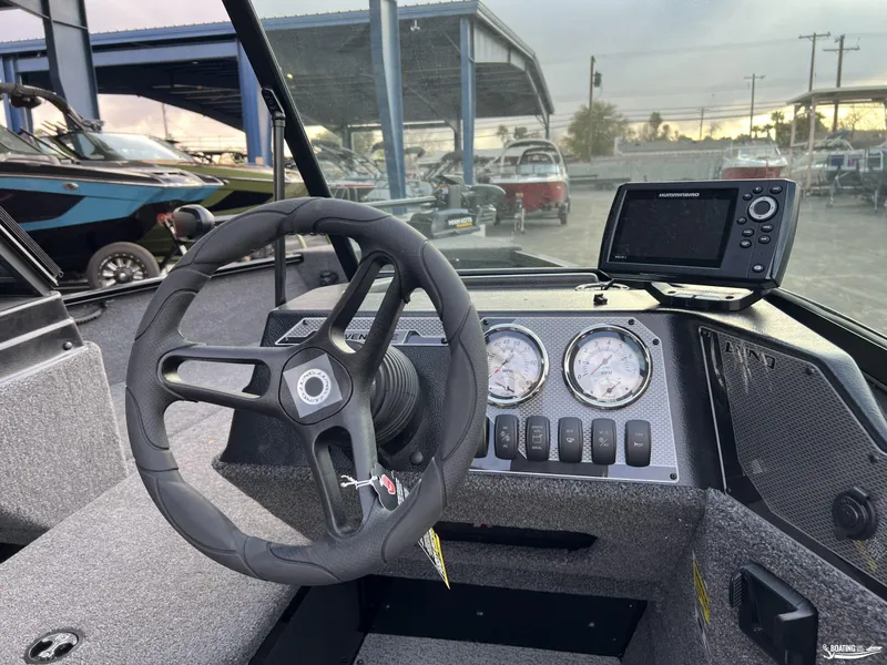 Slide: The Image of 2025 Lund 1675 Adventure Sport dashboard with steering wheel and navigation system. - 7