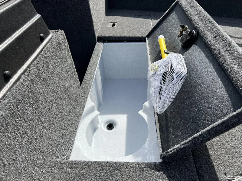 Slide: The Image of 2025 Lund 1650 Angler Sport boat storage compartment with fishing net. - 10