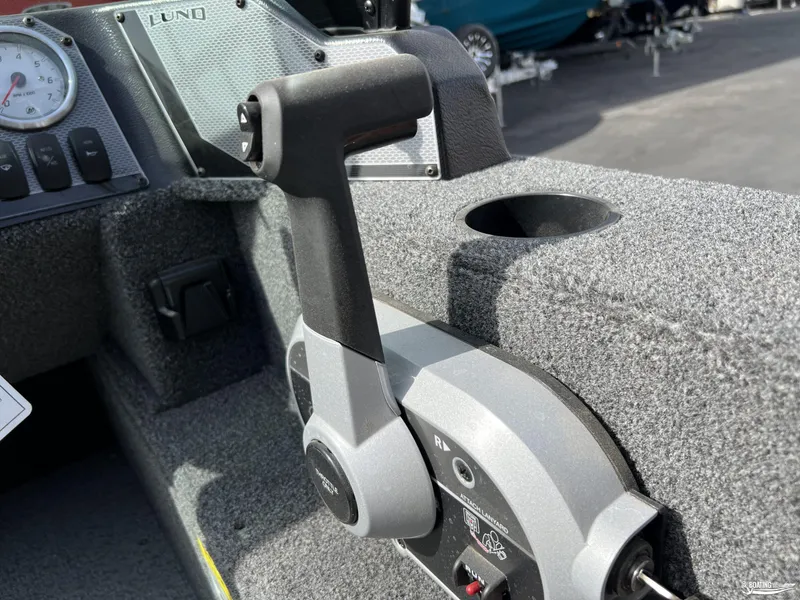 Slide: The Image of 2025 Lund 1650 Angler Sport boat throttle control, close-up view. - 11