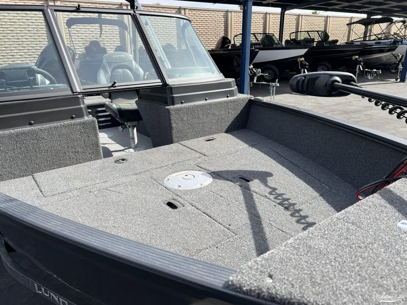 Slide: The Image of 2025 Lund 1650 Angler Sport boat interior with seating and storage compartments. - 4