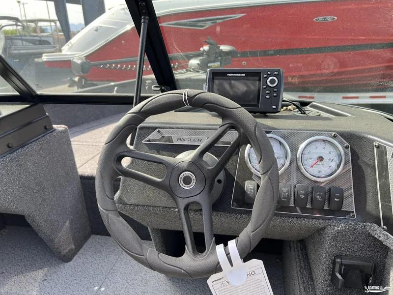 Slide: The Image of 2025 Lund 1650 Angler Sport dashboard with steering wheel and gauges. - 6