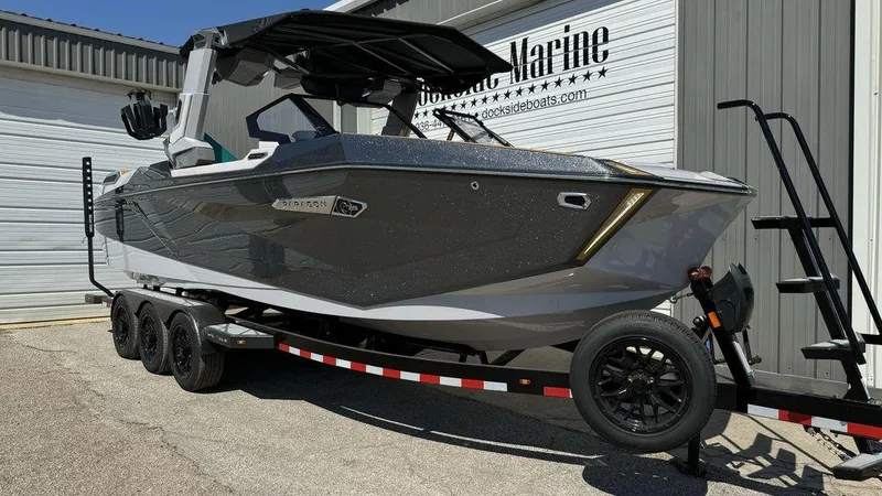 Slide: The Image of 2025 Nautique Paragon 25 boat on trailer outside Dockside Marine. - 1