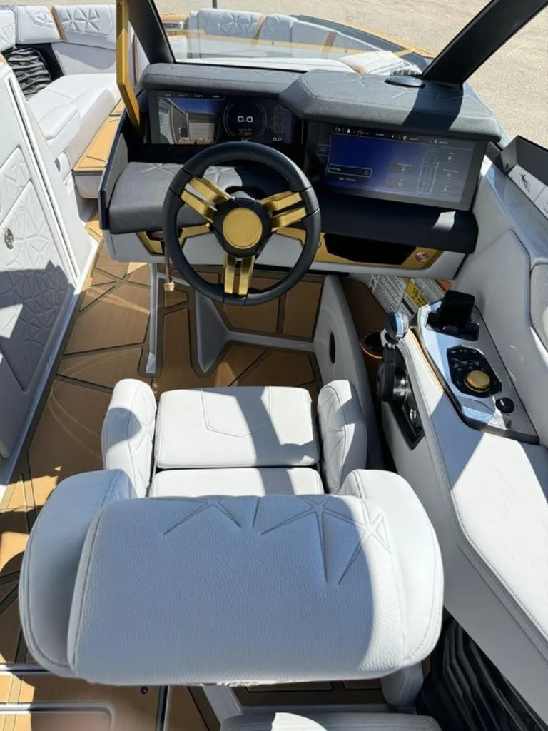Slide: The Image of 2025 Nautique Paragon 25 boat interior with modern dashboard and luxurious seating. - 10