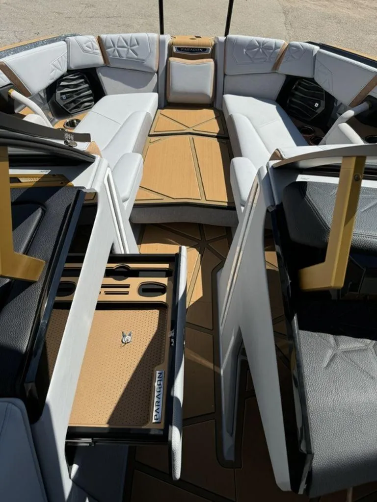 Slide: The Image of 2025 Nautique Paragon 25 boat interior with luxurious seating and storage compartments. - 11
