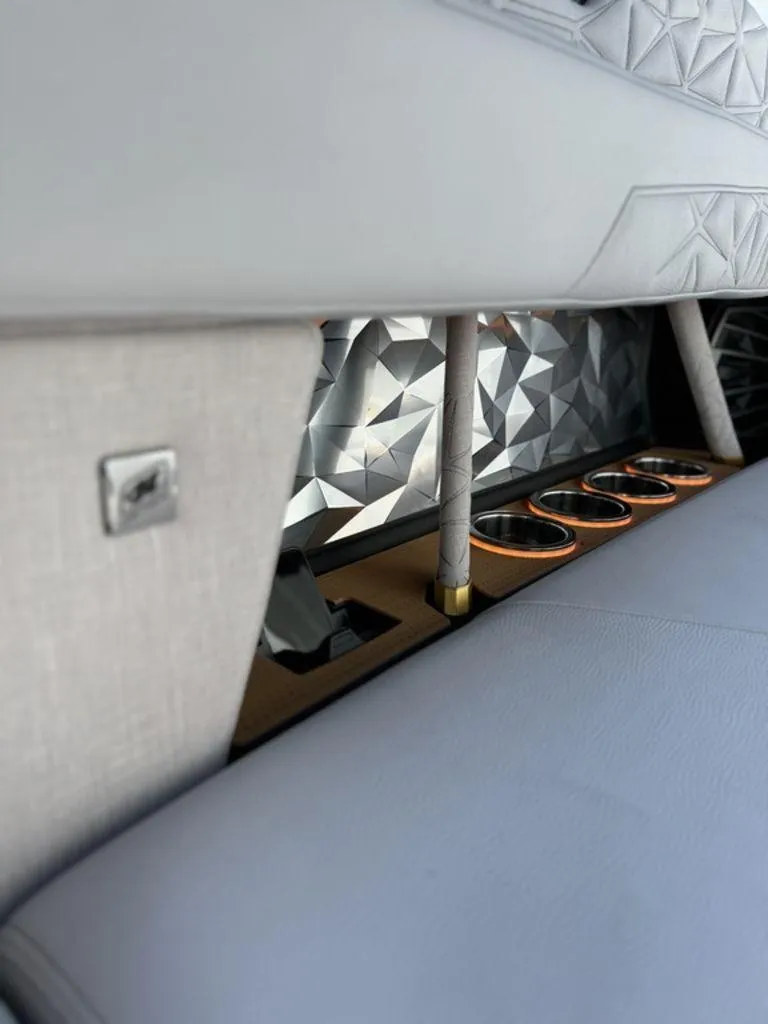 Slide: The Image of 2025 Nautique Paragon 25 interior with geometric design and cup holders. - 12