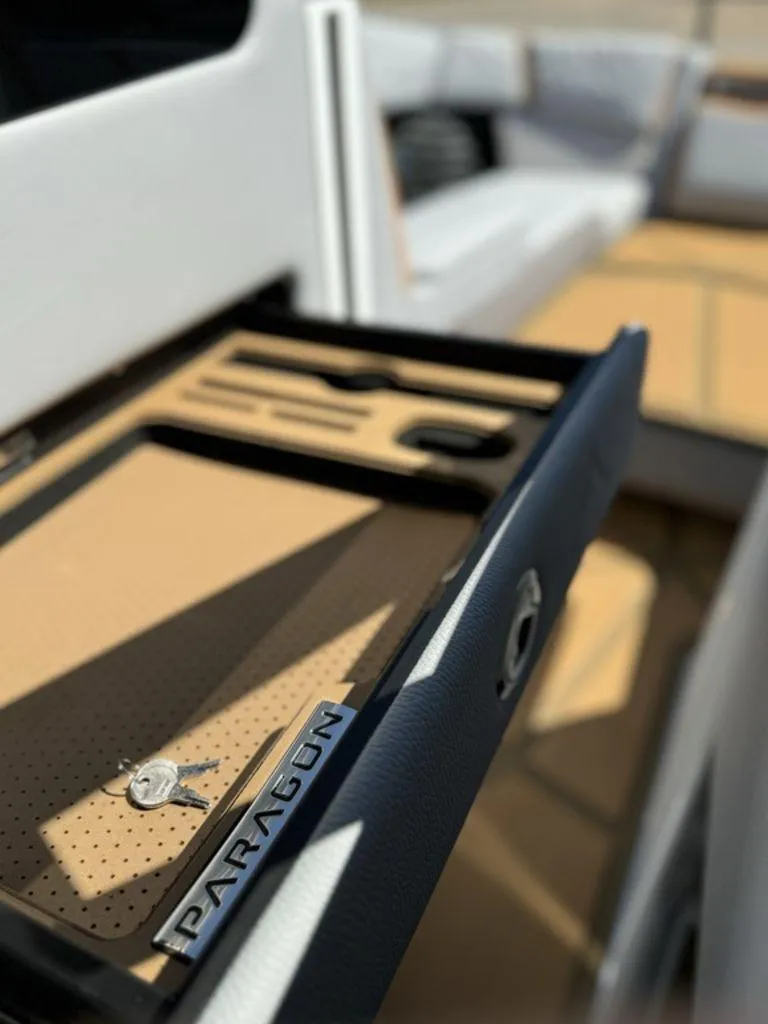 Slide: The Image of 2025 Nautique Paragon 25 interior with key holder and seating area. - 15