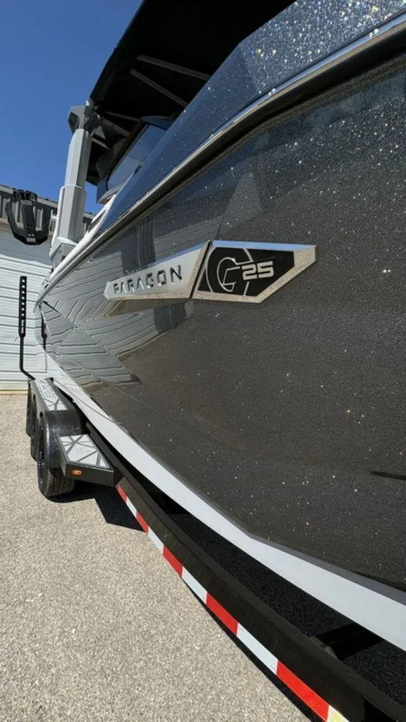 Slide: The Image of 2025 Nautique Paragon 25 boat side view with sleek design and logo. - 20