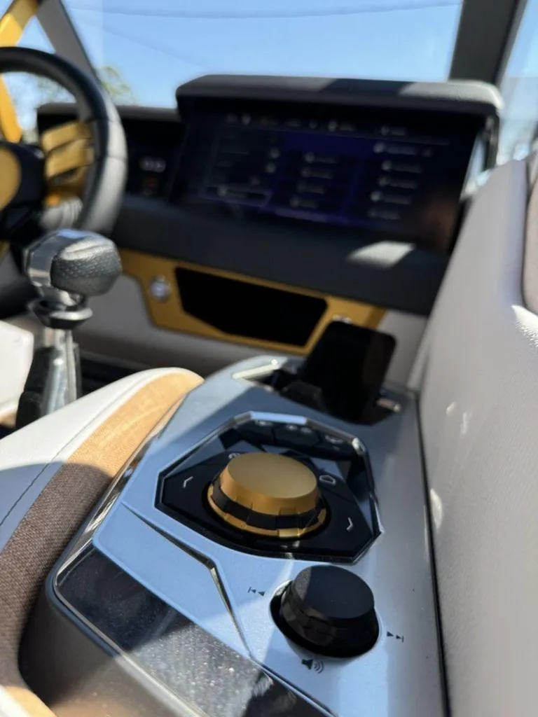 Slide: The Image of 2025 Nautique Paragon 25 interior dashboard with modern controls and sleek design. - 4
