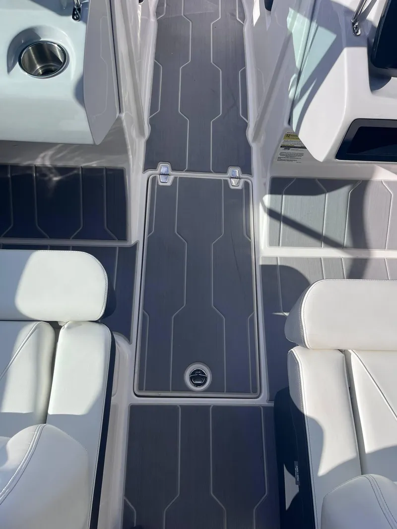 Slide: The Image of 2022 Regal LS2-CM boat interior with sleek seating and modern flooring design. - 11