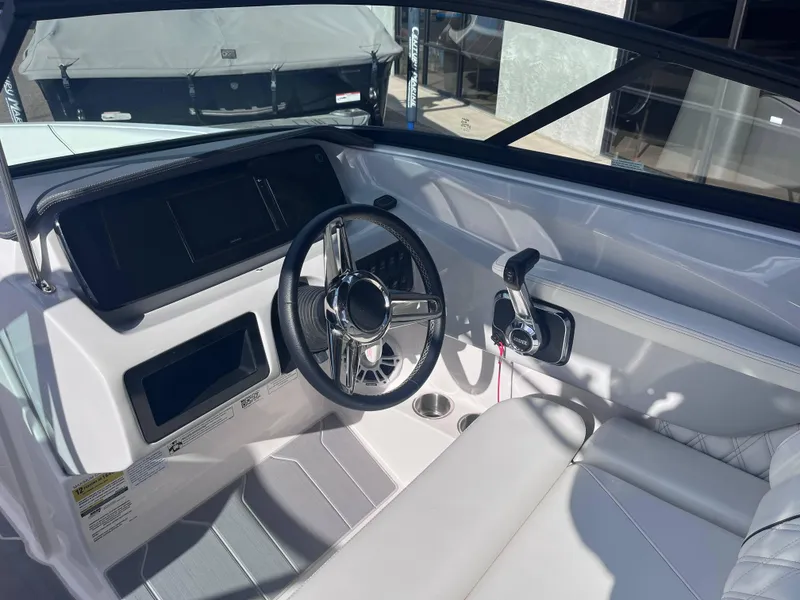 Slide: The Image of 2022 Regal LS2-CM boat interior with steering wheel and controls. - 12