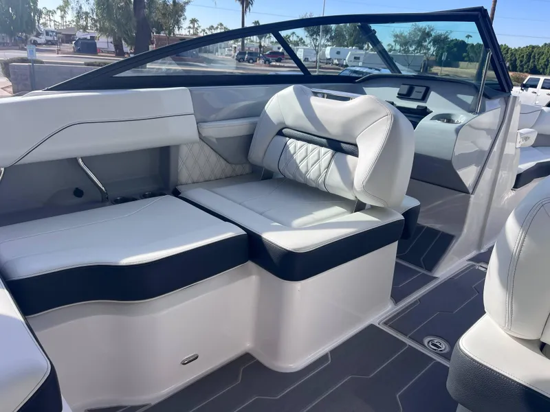 Slide: The Image of 2022 Regal LS2-CM boat interior with white leather seating and modern dashboard. - 13