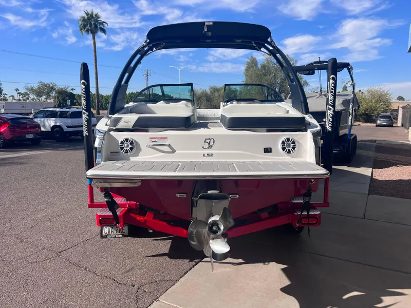 Slide: The Image of 2022 Regal LS2-CM boat on trailer, parked outdoors under a clear sky. - 3