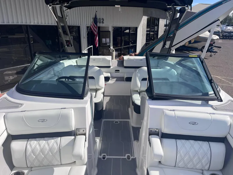 Slide: The Image of 2022 Regal LS2-CM boat interior with white leather seats and open windshield. - 6