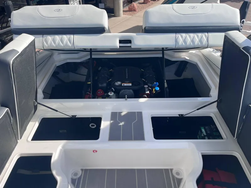 Slide: The Image of 2022 Regal LS2-CM boat engine compartment with open hatches and visible engine components. - 9