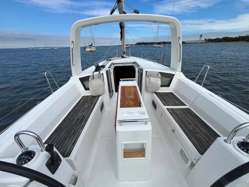 Slide: The Image of 2018 Beneteau Oceanis 35.1 sailboat cockpit with seating, on calm water. - 12