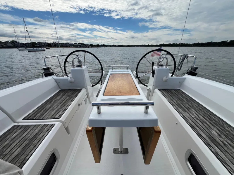 Slide: The Image of Cockpit view of 2018 Beneteau Oceanis 35.1 sailboat with dual steering wheels on calm water. - 13