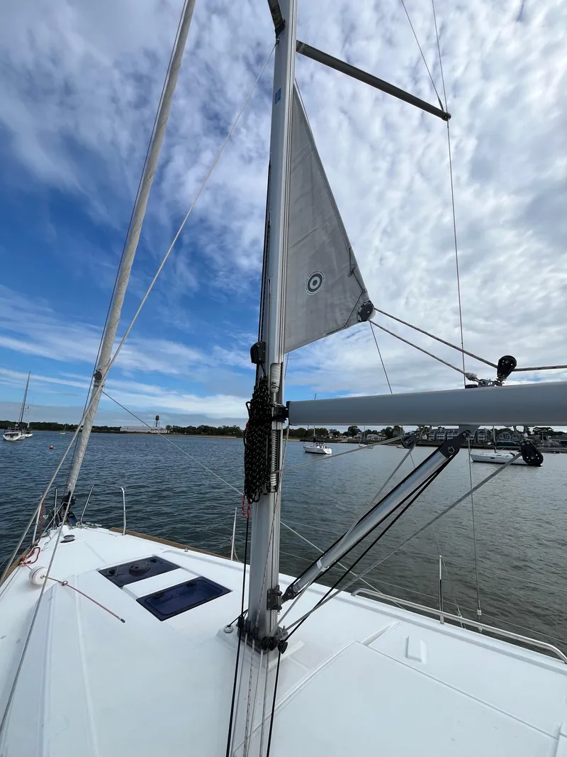 Slide: The Image of 2018 Beneteau Oceanis 35.1 sailboat on calm water under a partly cloudy sky. - 17
