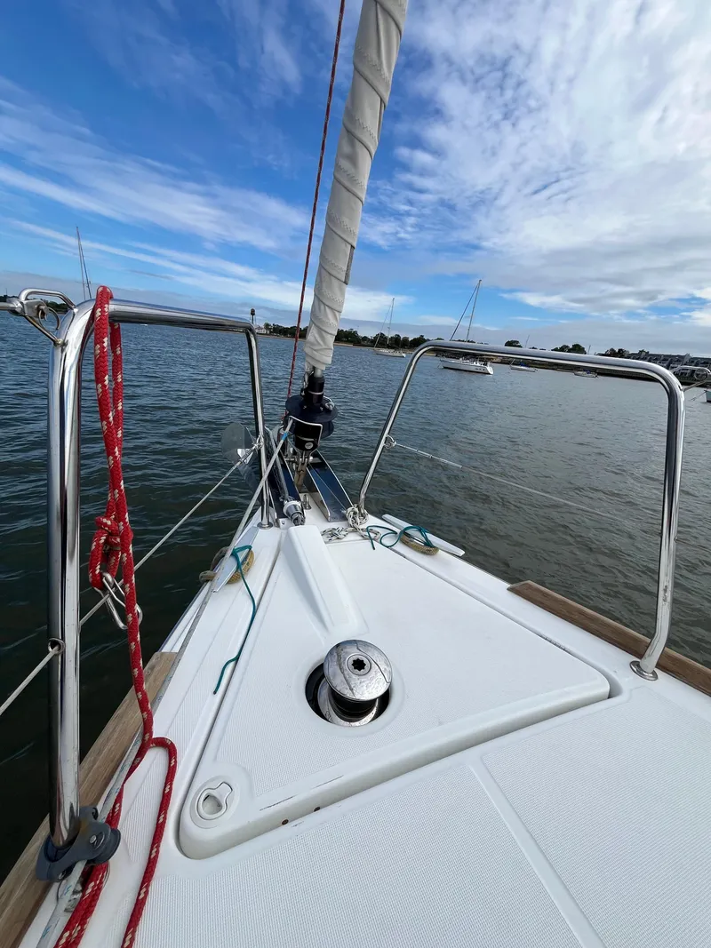 Slide: The Image of 2018 Beneteau Oceanis 35.1 sailboat deck with clear sky and calm waters. - 18