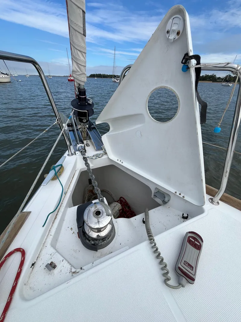 Slide: The Image of Beneteau Oceanis 35.1 sailboat anchor locker, 2018 model, open on calm water. - 19