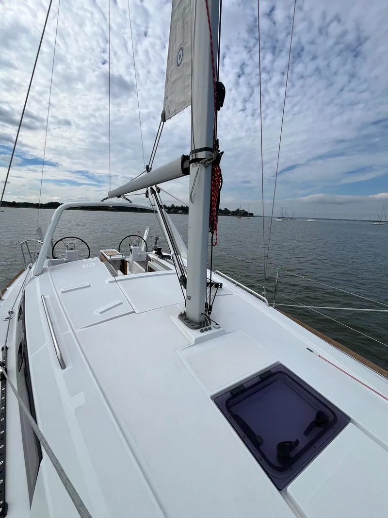 Slide: The Image of 2018 Beneteau Oceanis 35.1 sailboat on calm water under a cloudy sky. - 22