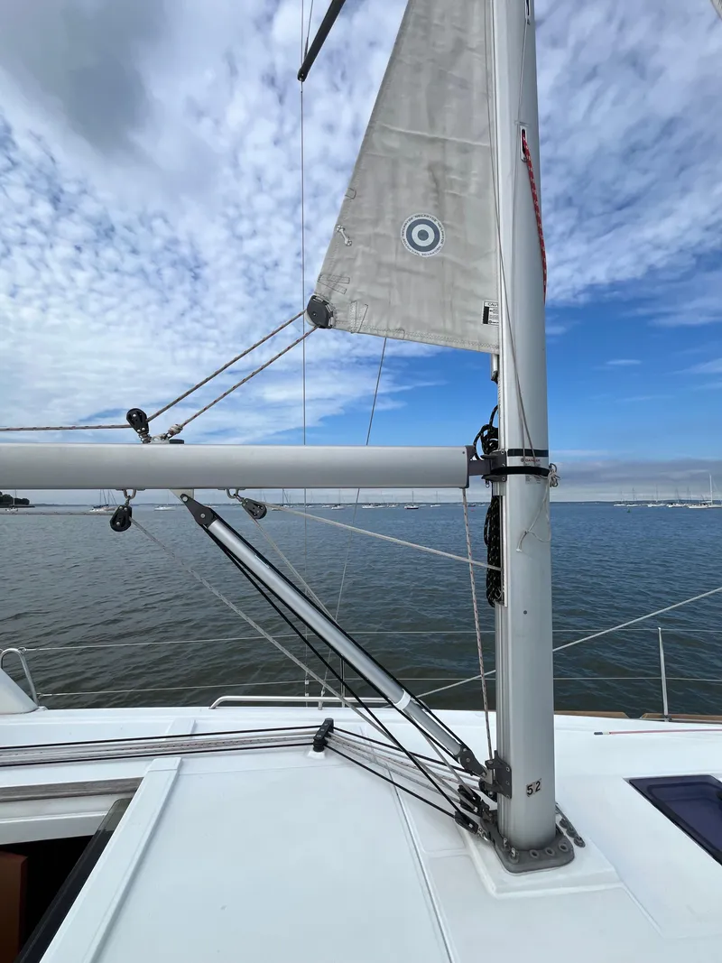 Slide: The Image of 2018 Beneteau Oceanis 35.1 sailboat mast and rigging against a cloudy sky. - 23