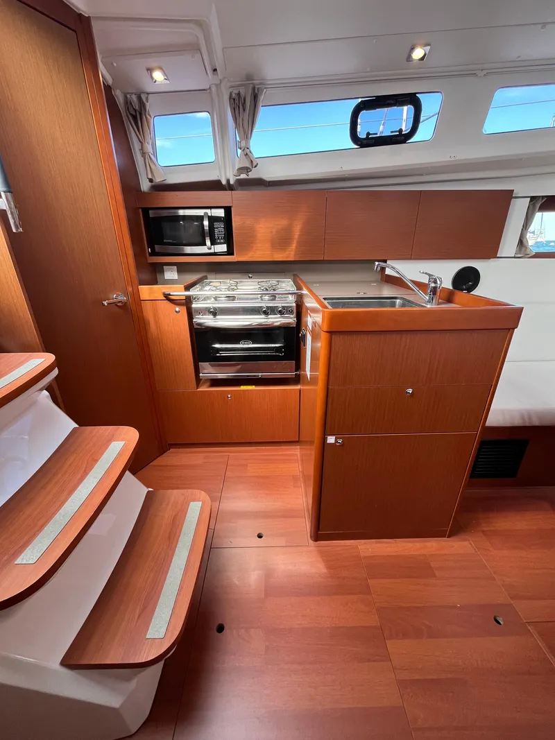 Slide: The Image of 2018 Beneteau Oceanis 35.1 yacht interior with modern kitchen and wooden flooring. - 30
