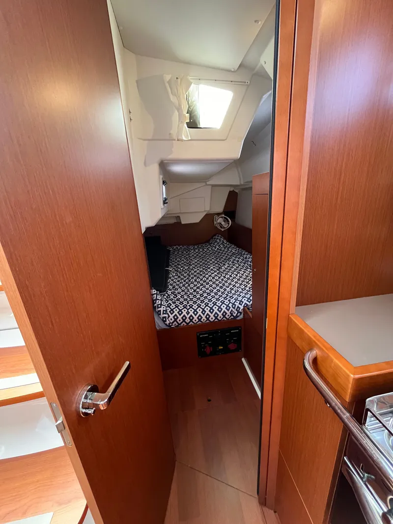 Slide: The Image of Interior cabin of 2018 Beneteau Oceanis 35.1 sailboat with cozy bed and wooden finish. - 32