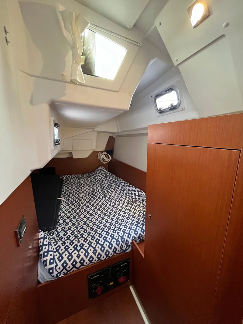 Slide: The Image of Cozy cabin interior of 2018 Beneteau Oceanis 35.1 sailboat with patterned bedding. - 33