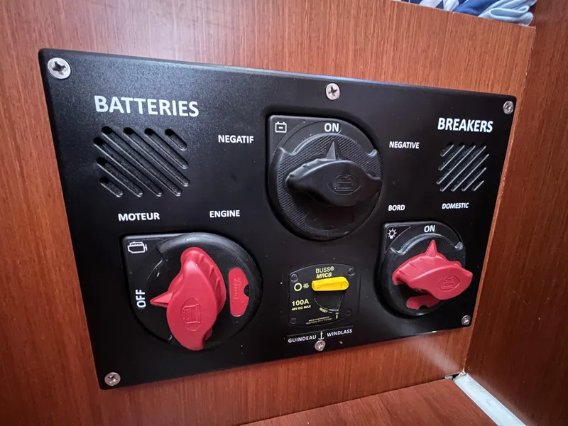 Slide: The Image of Electrical panel on a 2018 Beneteau Oceanis 35.1 sailboat, featuring battery and breaker switches. - 34