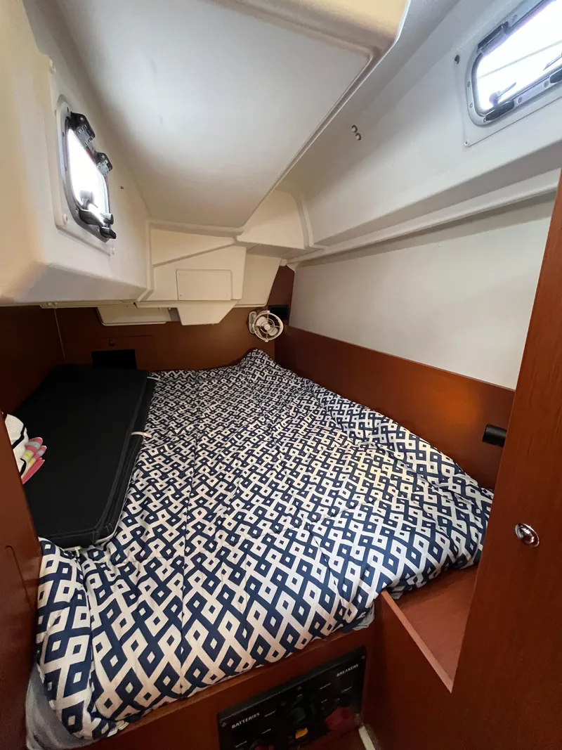Slide: The Image of Cozy cabin interior of 2018 Beneteau Oceanis 35.1 with patterned bedding. - 35