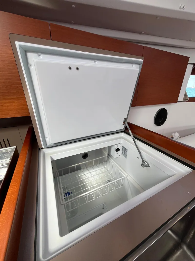 Slide: The Image of Beneteau Oceanis 35.1 2018 yacht interior with open refrigerator in the galley. - 41