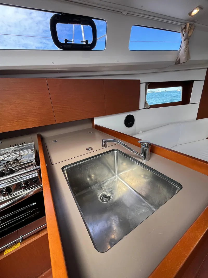 Slide: The Image of Interior of 2018 Beneteau Oceanis 35.1 yacht kitchen with sink and stove. - 42