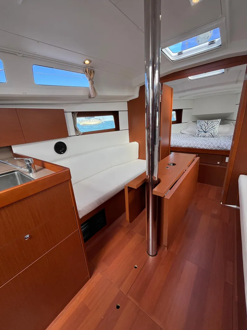 Slide: The Image of Interior of 2018 Beneteau Oceanis 35.1 sailboat with wood finish and cozy seating area. - 44